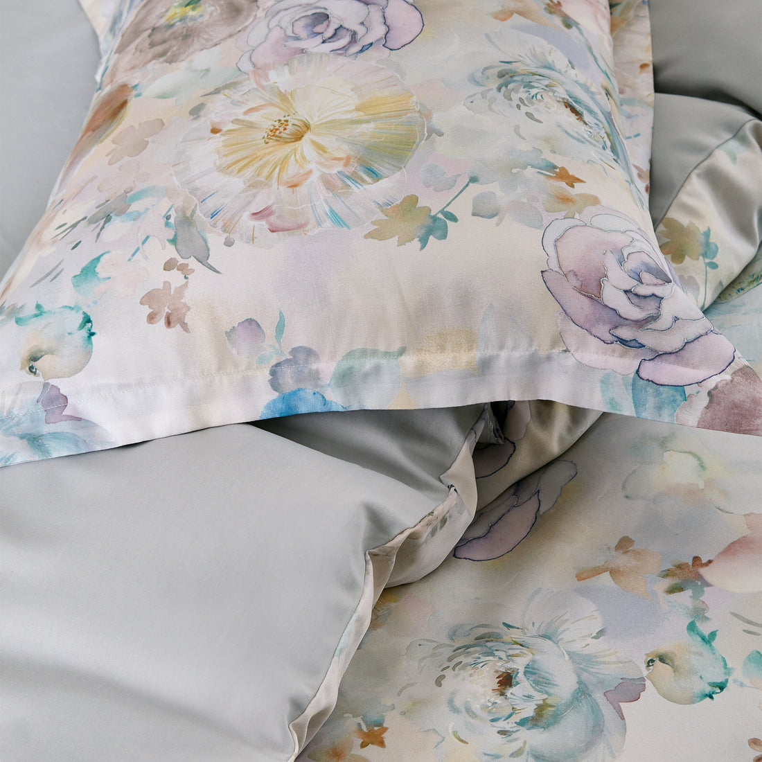 Floral patterned pillow and bedding on a bed