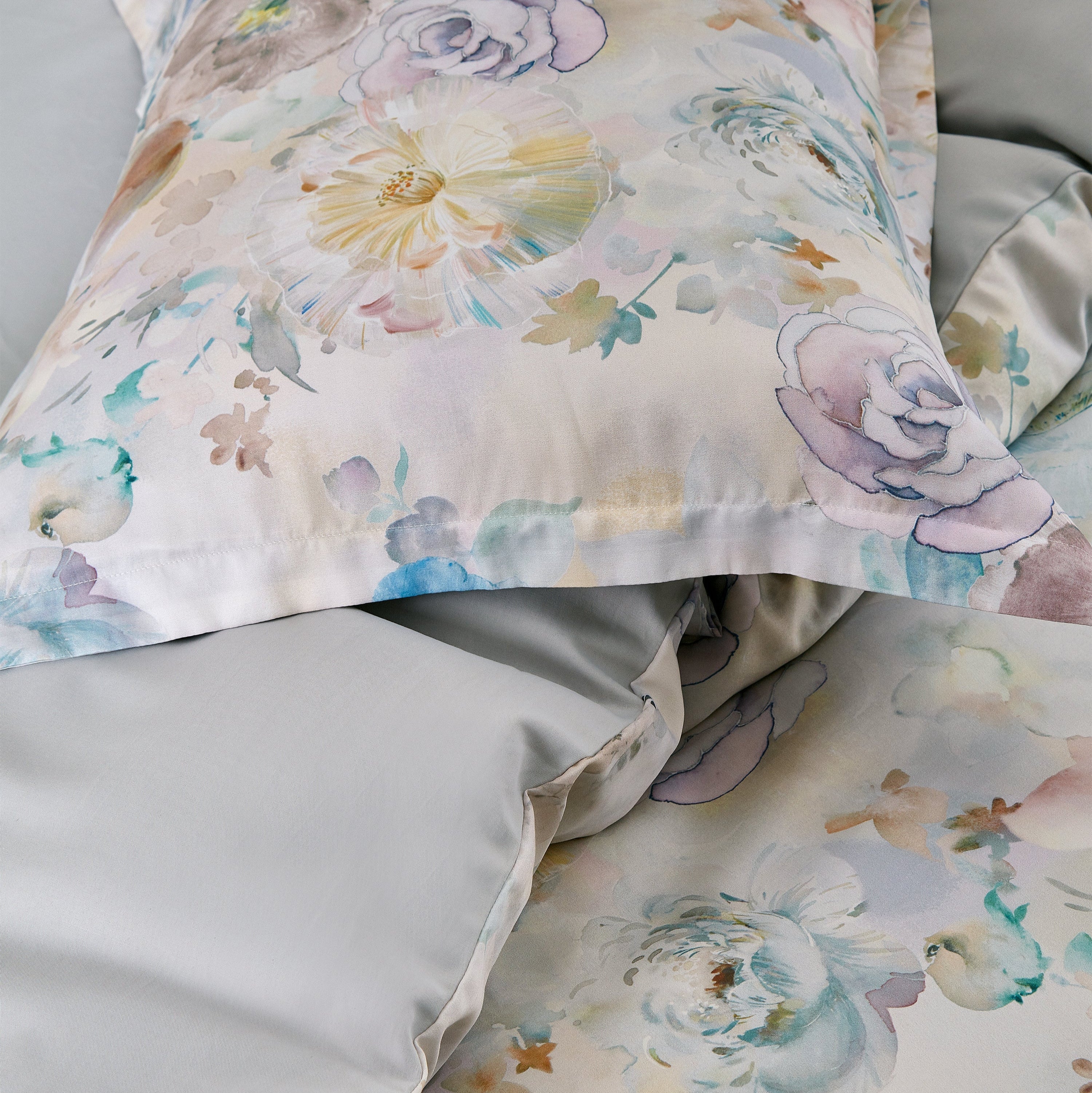 Floral patterned pillow and bedding on a bed